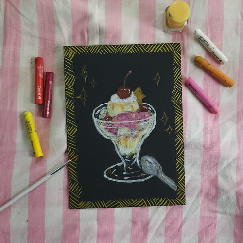 A square black art print or card featuring a hand-drawn ice cream sundae in a glass with a cherry on top, surrounded by crayons and a paintbrush on a pink and white striped fabric background.
