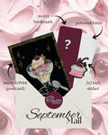 A promotional graphic for a 'September Mail' surprise card set by 'The Taste Diaries', showing a cream-colored envelope with a black and gold postcard featuring an ice cream sundae, a dark red postcard with a question mark, and a sticker, all labeled with arrows and text against a pink whipped cream and cherries background.